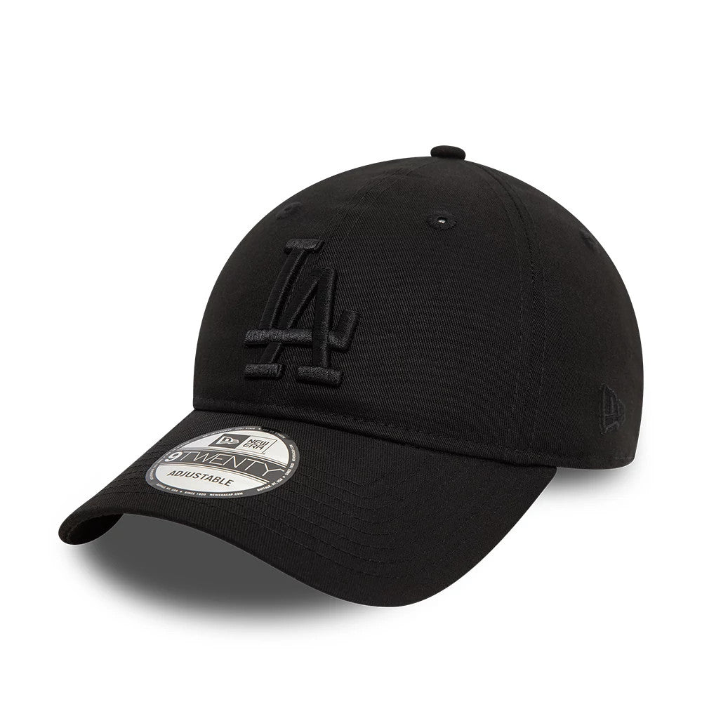 LA Dodgers League Essential Black New Era 9TWENTY Adjustable Cap, three-quarter view showing the raised black embroidered LA logo on the front panel, curved visor with 9TWENTY size sticker, and New Era flag logo on the left side.