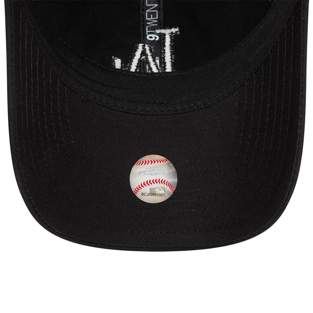 LA Dodgers League Essential Black New Era 9TWENTY Adjustable Cap, inside view showing black taping with a 9TWENTY logo and a baseball graphic sticker on the underside of the black visor.