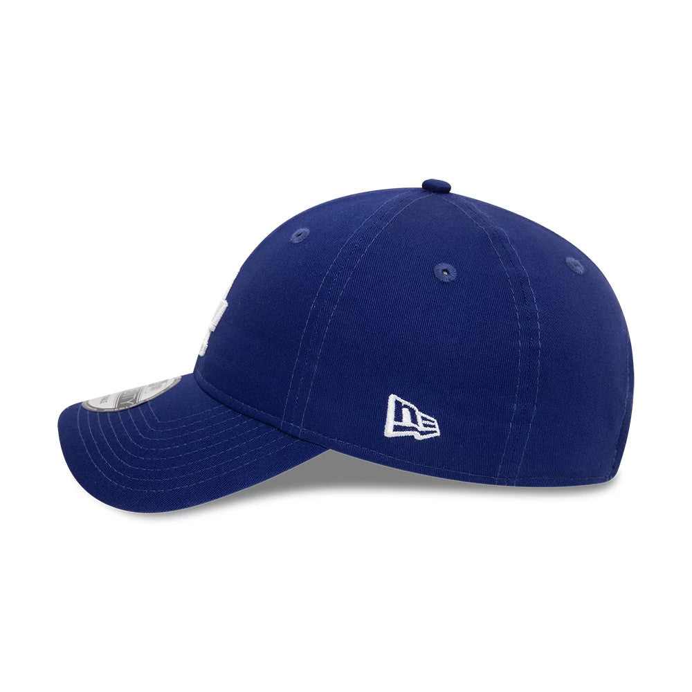 LA Dodgers League Essential Dark Blue New Era 9TWENTY Adjustable Cap, side view showing the white New Era flag logo on the left side, a curved visor with a 9TWENTY size sticker, and a structured dark blue crown with matching eyelets.