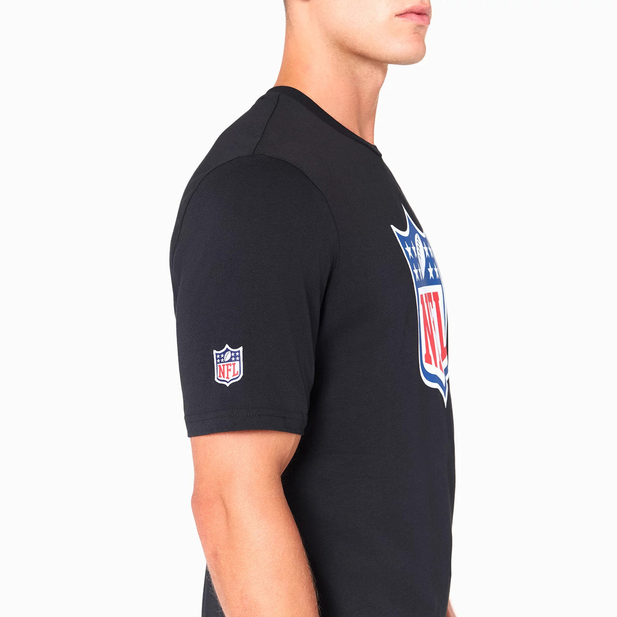New Era NFL Shield Logo NFL Black T-Shirt, side view showing the large multicoloured NFL shield logo printed on the chest and a smaller embroidered NFL shield logo on the upper left sleeve of the plain black fabric.