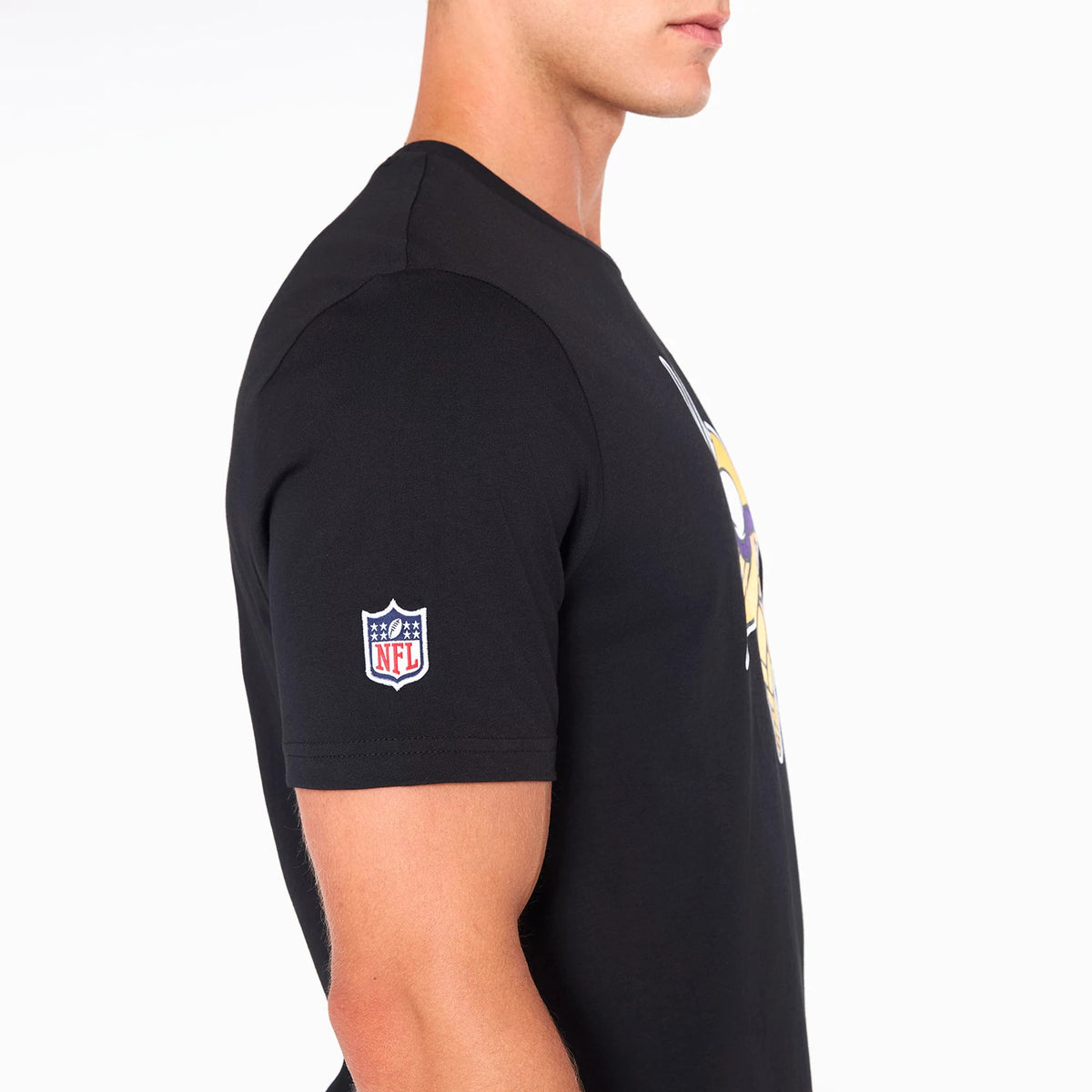 New Era Minnesota Vikings NFL Black T-Shirt, side view showing a fitted black shirt with a colourful team logo on the chest, an embroidered NFL logo on the sleeve, and a plain round neckline.