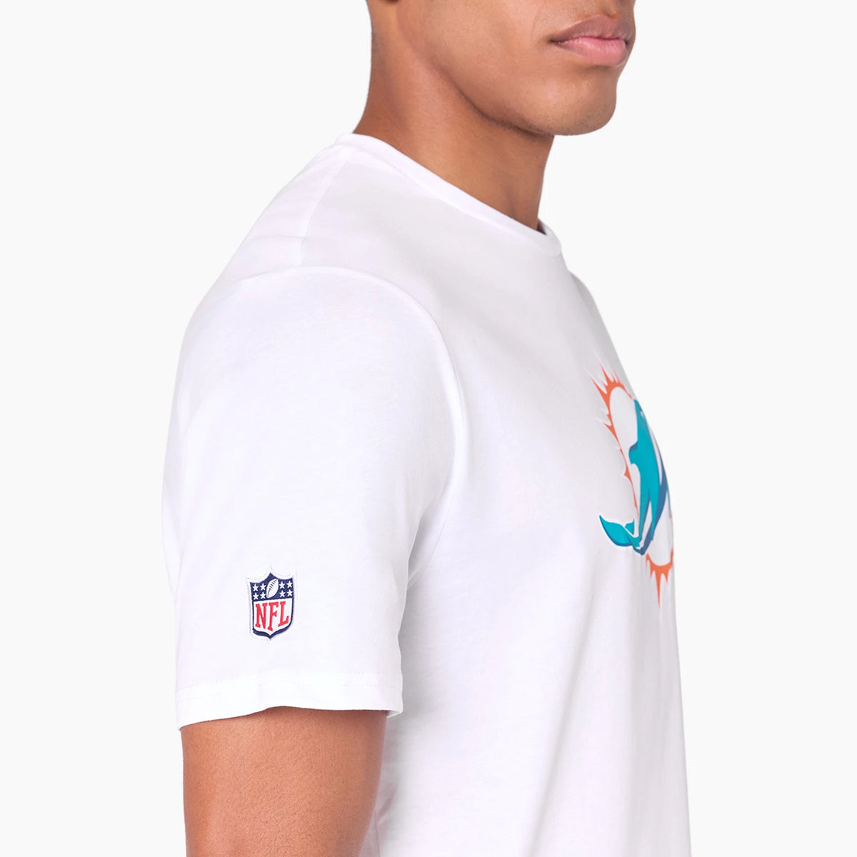 New Era Miami Dolphins NFL White T-Shirt, side view showing the white shirt with a large teal and orange Dolphins logo on the chest and an embroidered NFL shield logo on the sleeve.
