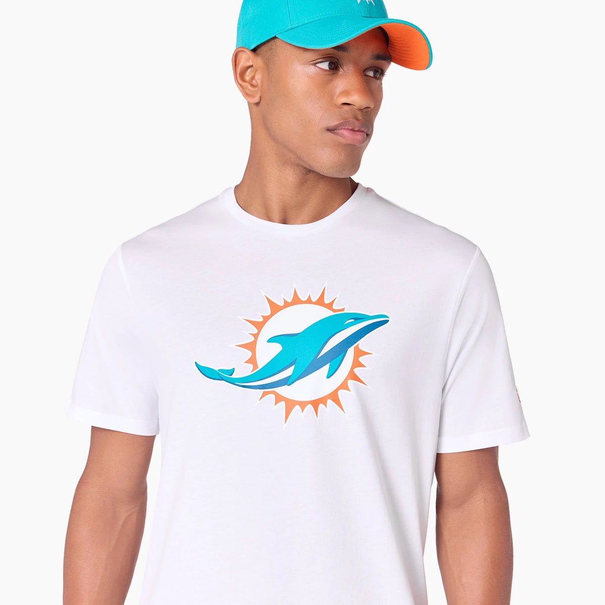 New Era Miami Dolphins NFL White T-Shirt, front view showing a large teal and orange dolphin logo centred on the chest, worn by a person also wearing a teal and orange New Era cap.