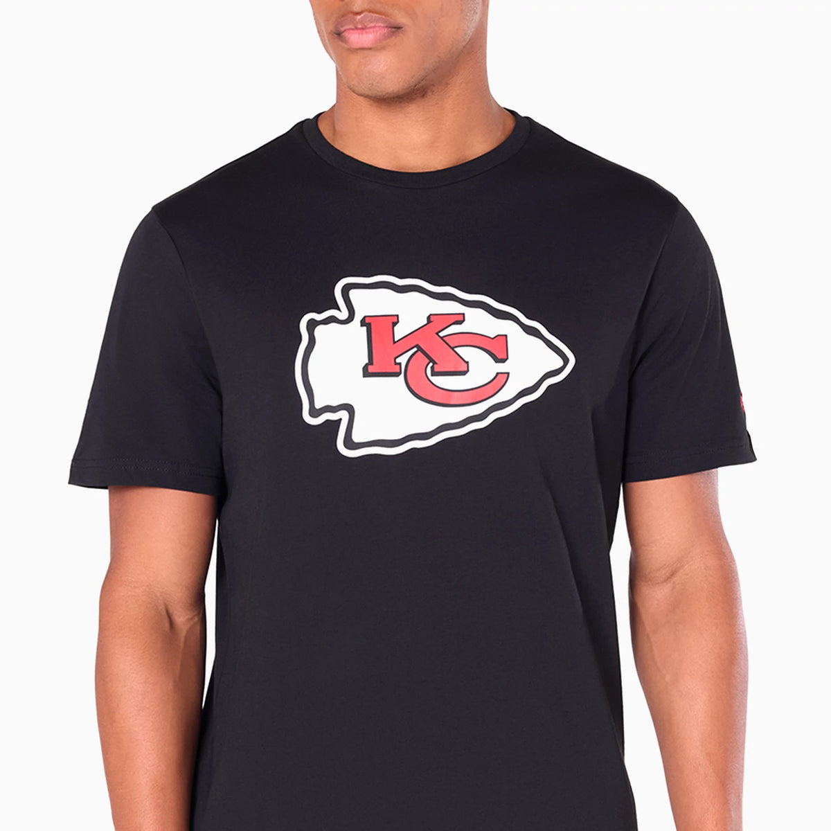 New Era Kansas City Chiefs NFL Black T-Shirt, front view showing the large Chiefs logo in red and white centred on the chest, worn on-model, with short sleeves and a round neckline.
