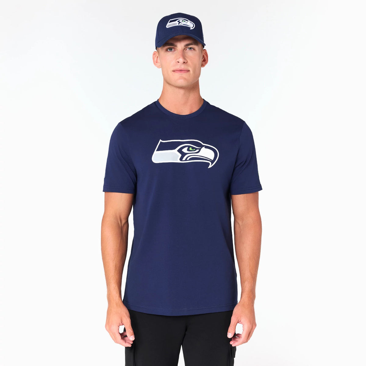 New Era Seattle Seahawks NFL Navy T-Shirt, front view showing a navy shirt with the white and green head logo of the Seattle Seahawks centred on the chest, paired with a navy cap featuring the same embroidered logo on the front.