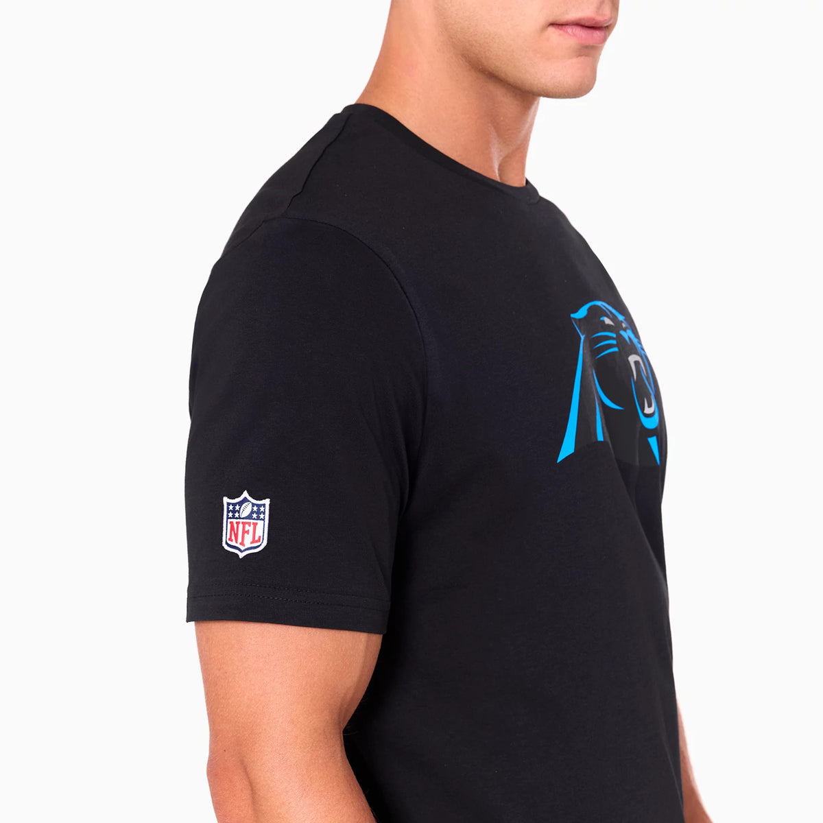 New Era Carolina Panthers NFL Black T-Shirt, side view showing the black shirt with a large blue and black Panthers logo on the chest and an embroidered NFL logo patch on the sleeve.