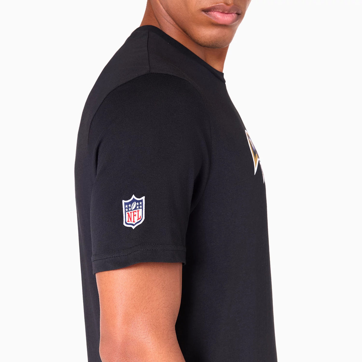 New Era Baltimore Ravens NFL Black T-Shirt, side view showing the black fabric with a raised NFL logo patch on the left sleeve and part of the front graphic peeking at the chest area.