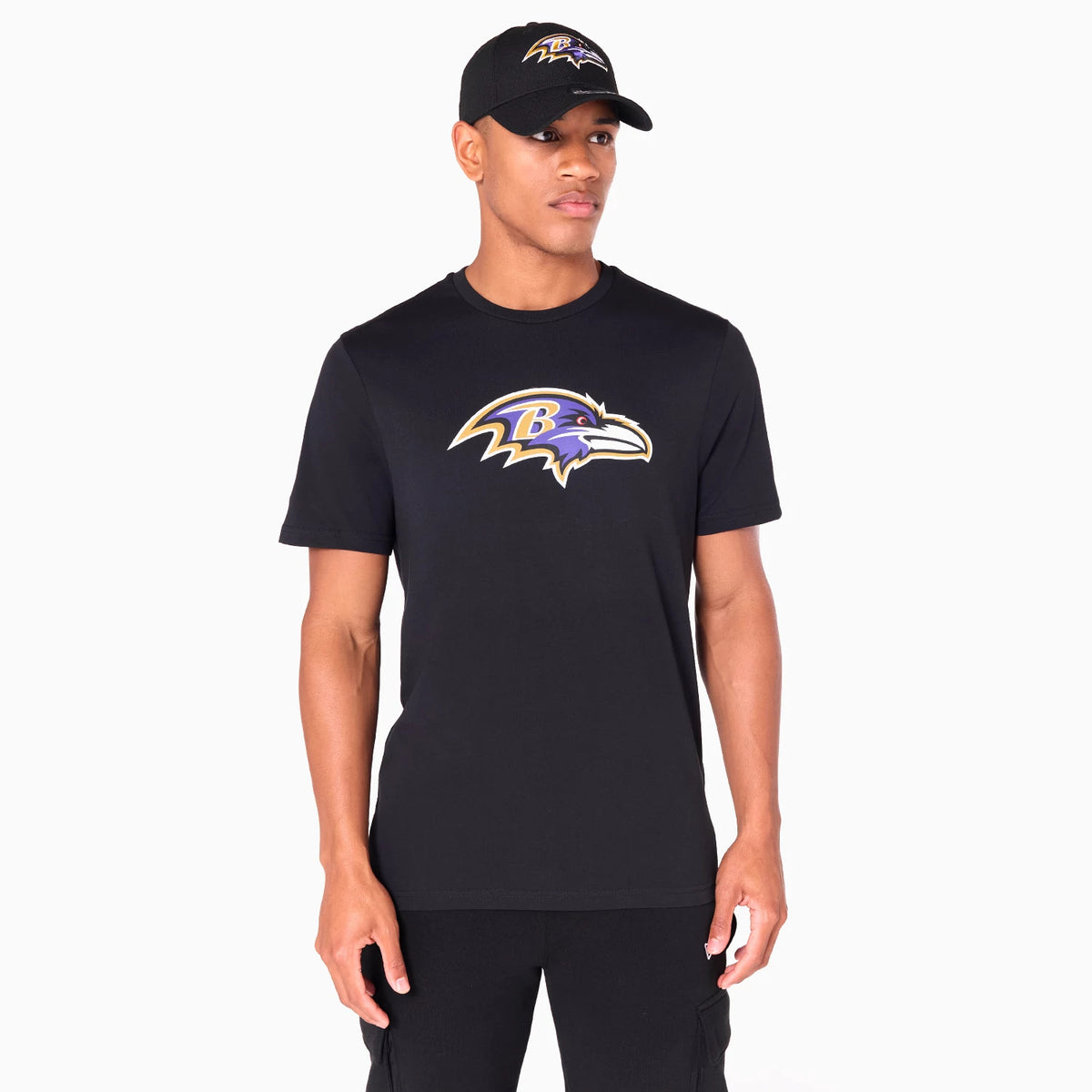 New Era Baltimore Ravens NFL Black T-Shirt, on-model view showing a black shirt with the Baltimore Ravens logo centred on the chest, paired with a black cap featuring the same raised logo above the visor.