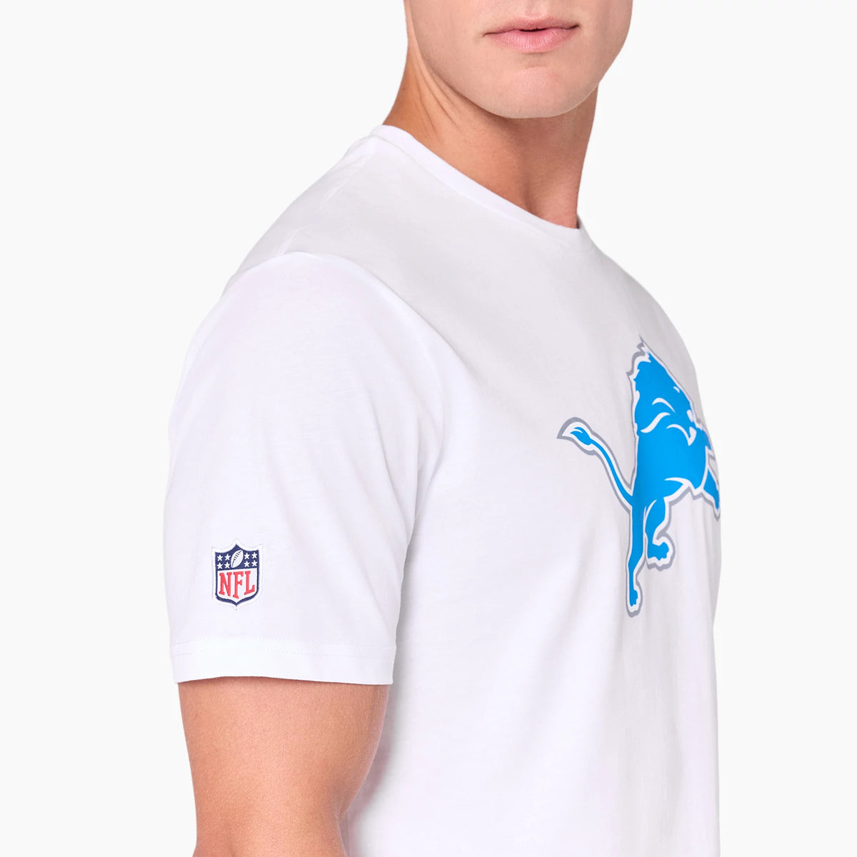 New Era Detroit Lions NFL White T-Shirt, side view showing a blue lion graphic on the chest, an embroidered NFL logo on the sleeve, and the white fabric extending across the shoulder and upper arm area.