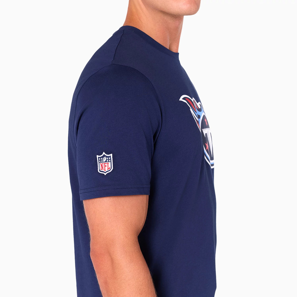 New Era Tennessee Titans NFL Navy T-Shirt, side view showing the navy fabric with a large printed Titans logo on the chest and an embroidered NFL shield logo on the left sleeve above the hem.