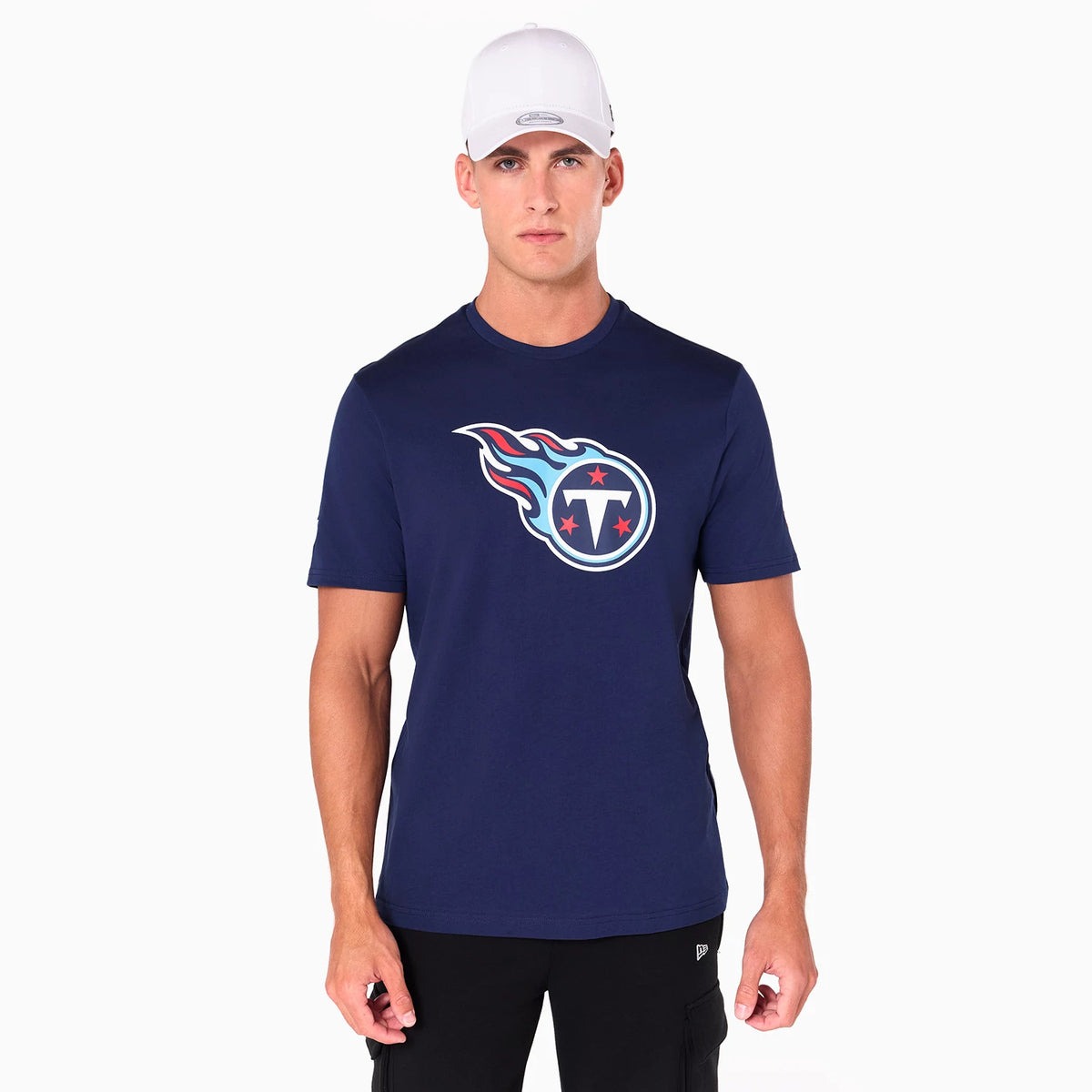 New Era Tennessee Titans NFL Navy T-Shirt, on-model view showing the navy shirt featuring the team logo centred on the chest in white, red, and light blue, worn by a person with a white debossed New Era cap.