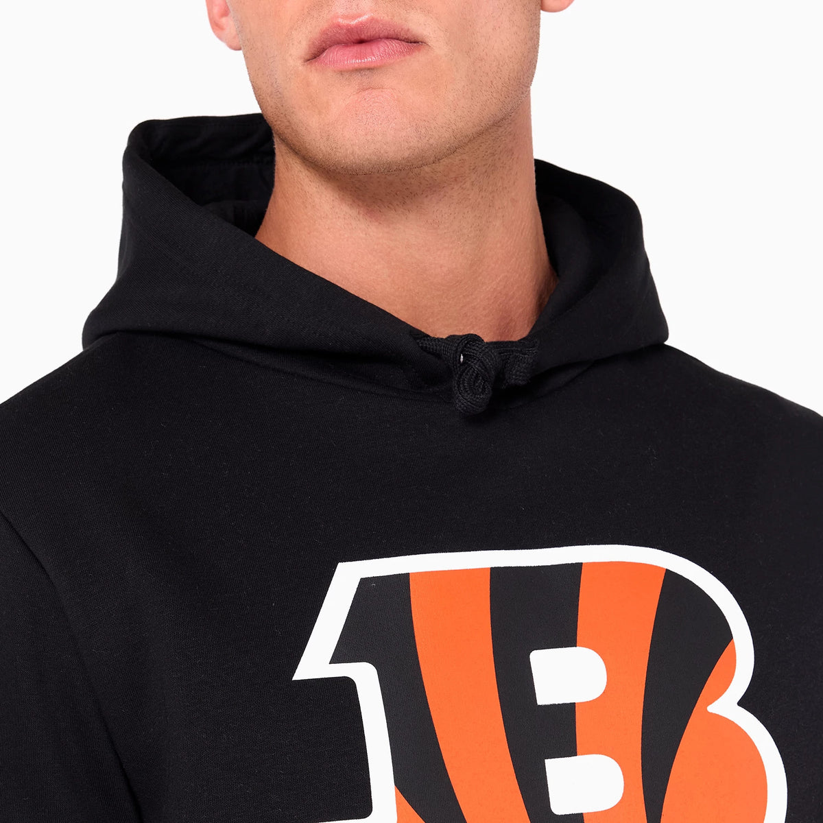 New Era Cincinnati Bengals NFL Black Pullover Hoodie, on-model view showing the black hood with black drawstrings and a bold orange and black B logo centred on the chest.