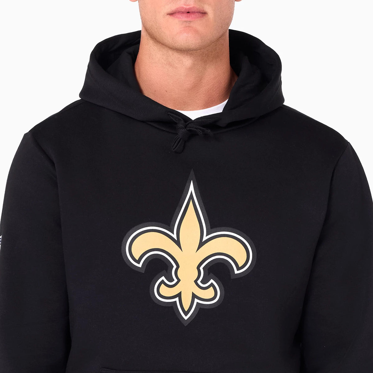 New Era New Orleans Saints NFL Black Pullover Hoodie, front view showing a large gold fleur-de-lis logo centred on the chest, a drawstring hood, and a kangaroo pocket at the bottom.