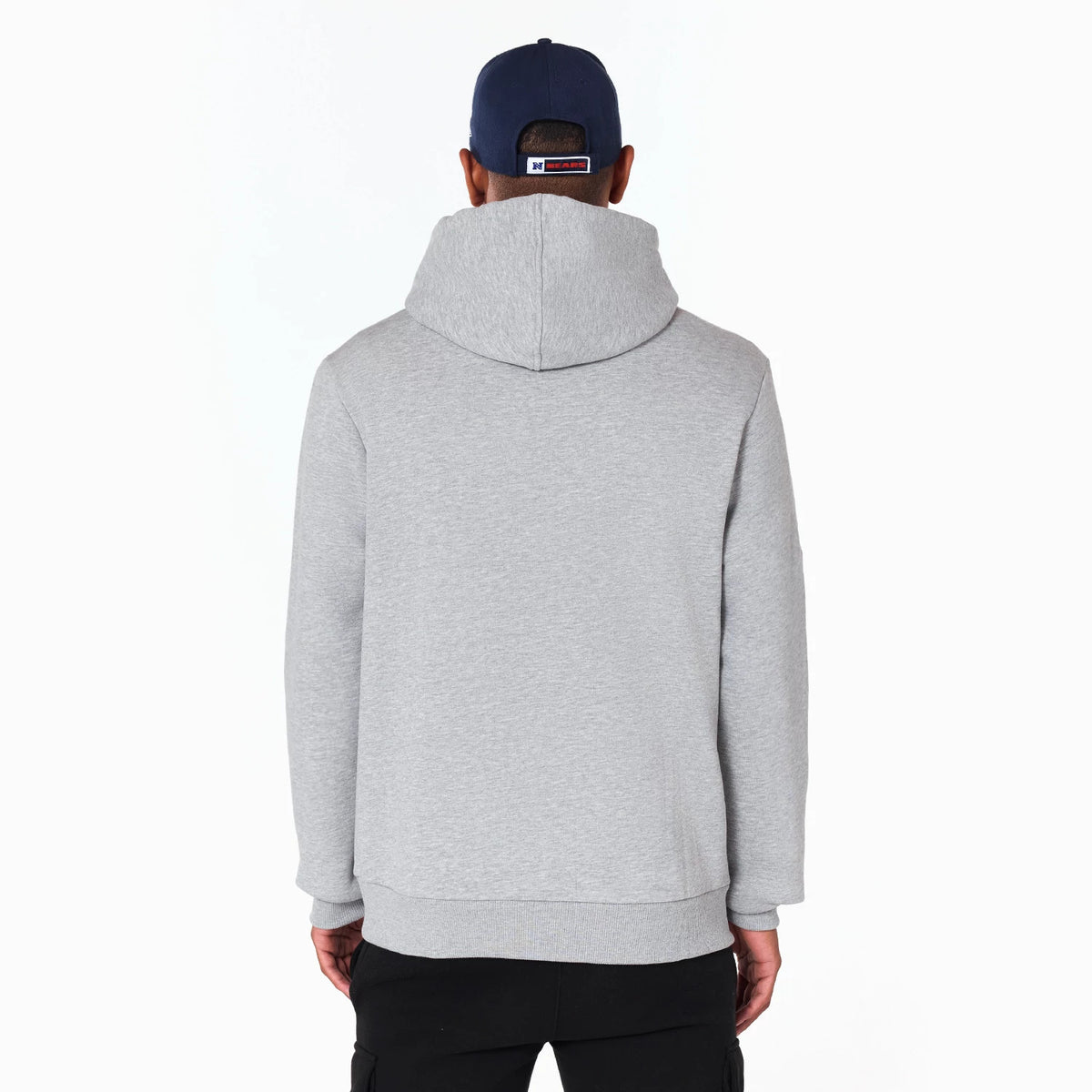 New Era Chicago Bears NFL Grey Pullover Hoodie, rear view showing the plain grey back with a large hood, worn by a person in a navy cap with an embroidered logo on a purple cap beneath.