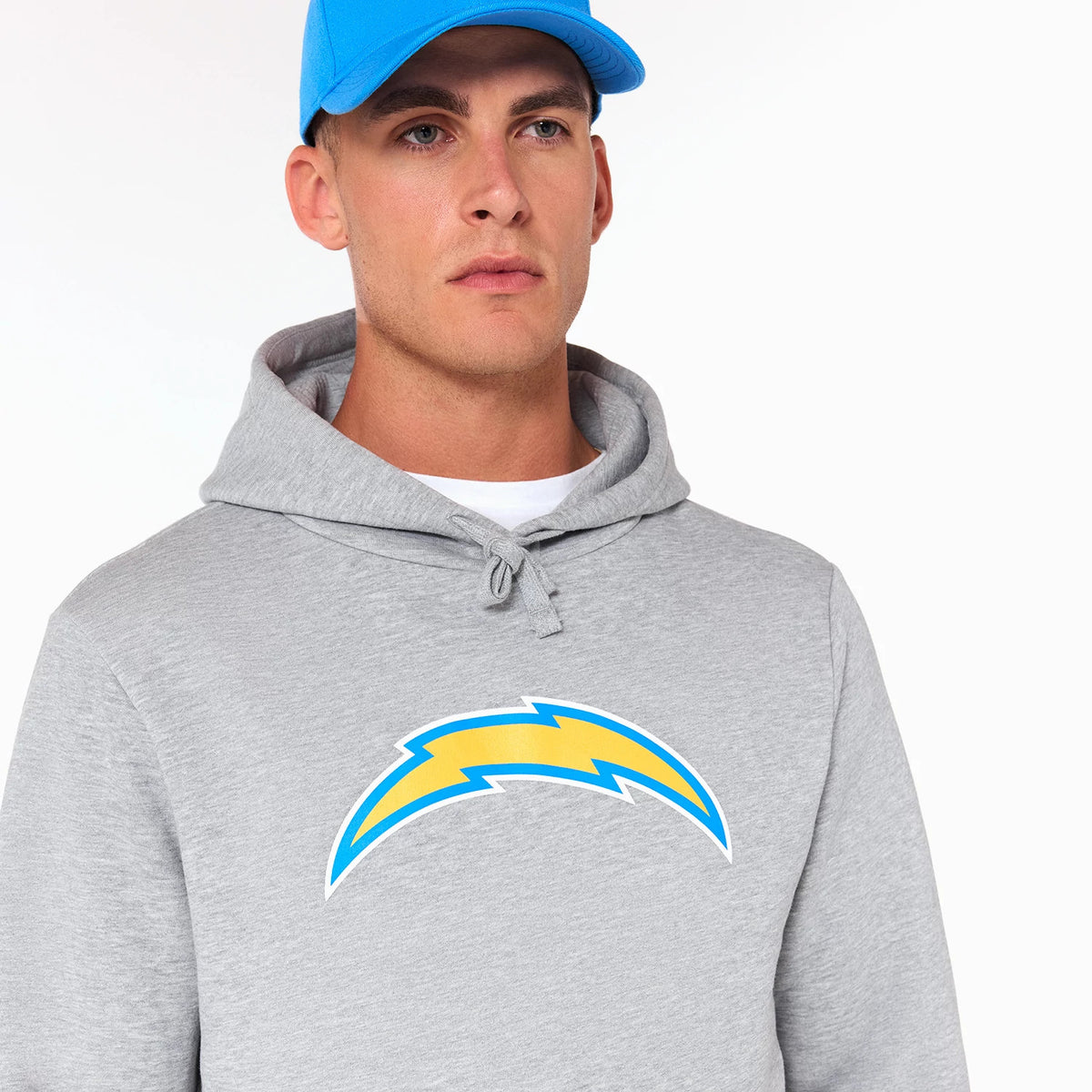 New Era LA Chargers NFL Grey Pullover Hoodie, front view showing the grey fabric with a large printed yellow and blue LA Chargers logo centred on the chest and a drawstring hood at the top.
