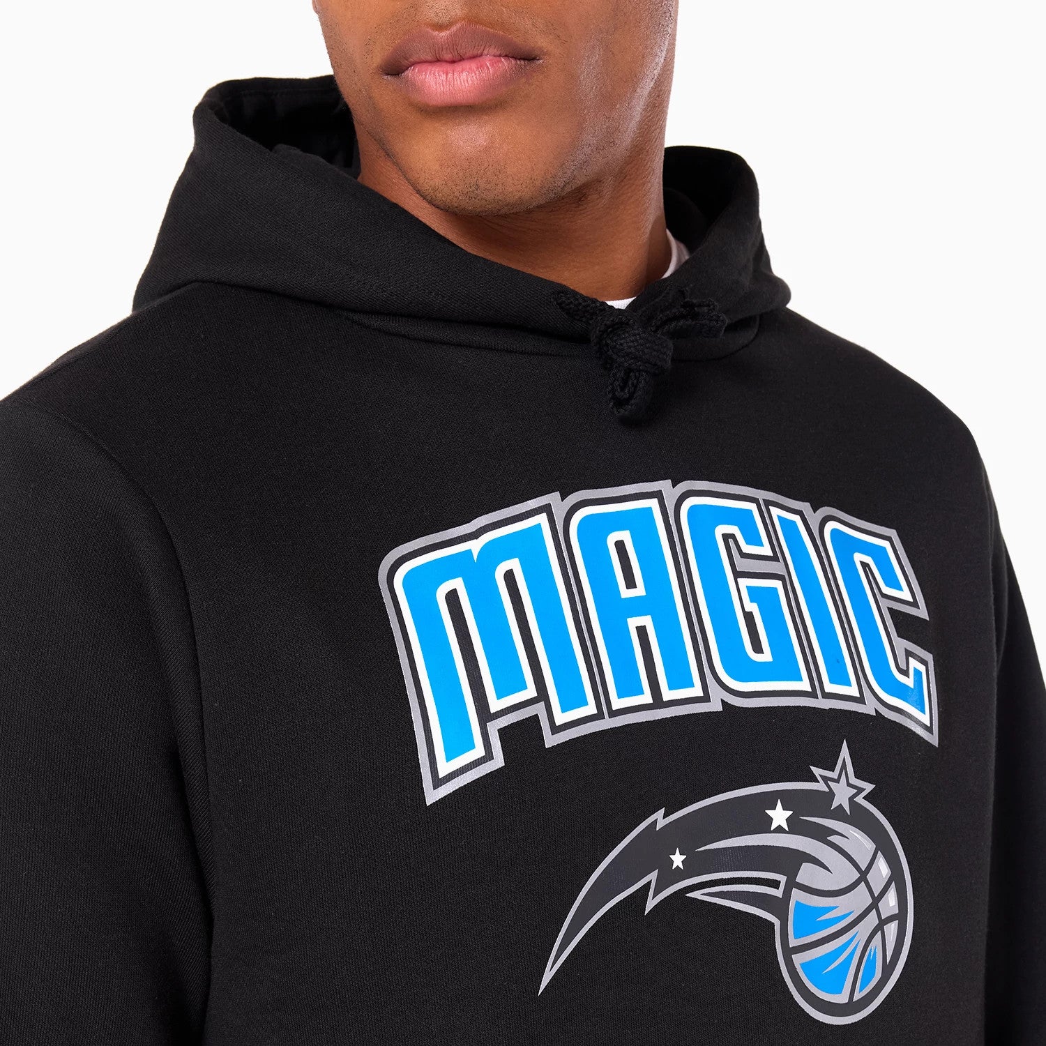 New Era Orlando Magic NBA Black Pullover Hoodie, front view showing the MAGIC text logo in white and blue across the chest, matching team emblem below, and a black drawstring hood, worn by a model.