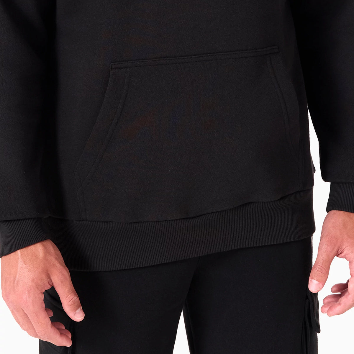 New Era Golden State Warriors NBA Black Pullover Hoodie, front view showing the kangaroo pocket at the waist, ribbed hem, and plain black fabric extending to the sleeves without any visible logos or additional features.