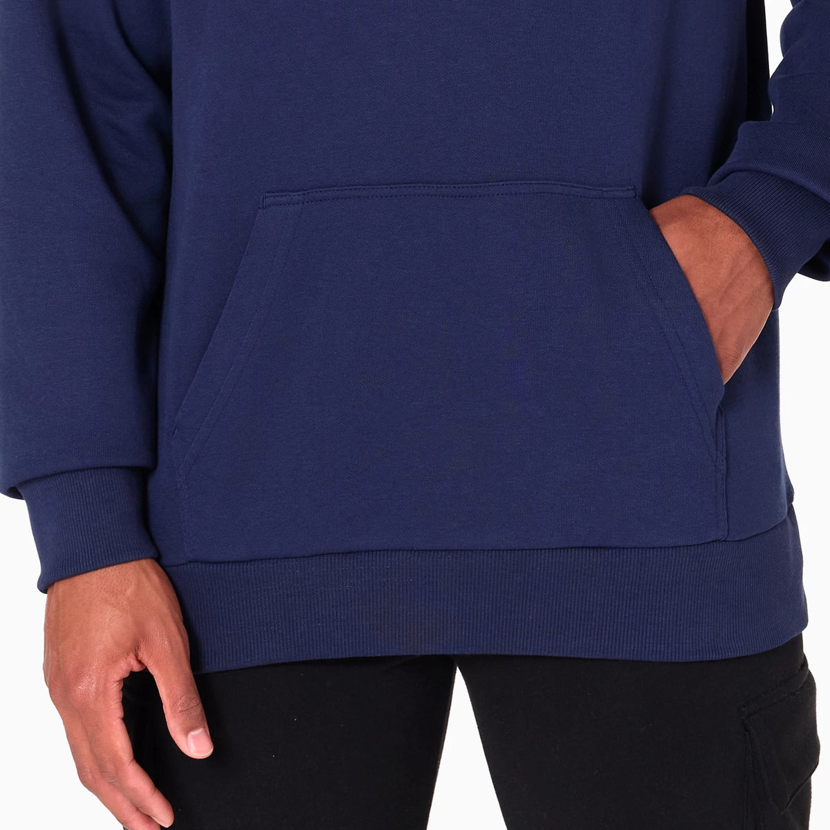 New Era Memphis Grizzlies NBA Navy Pullover Hoodie, front view showing the central kangaroo pocket, ribbed hem, and sleeves on a deep navy hoodie worn by a model with hands partially tucked in the pocket.