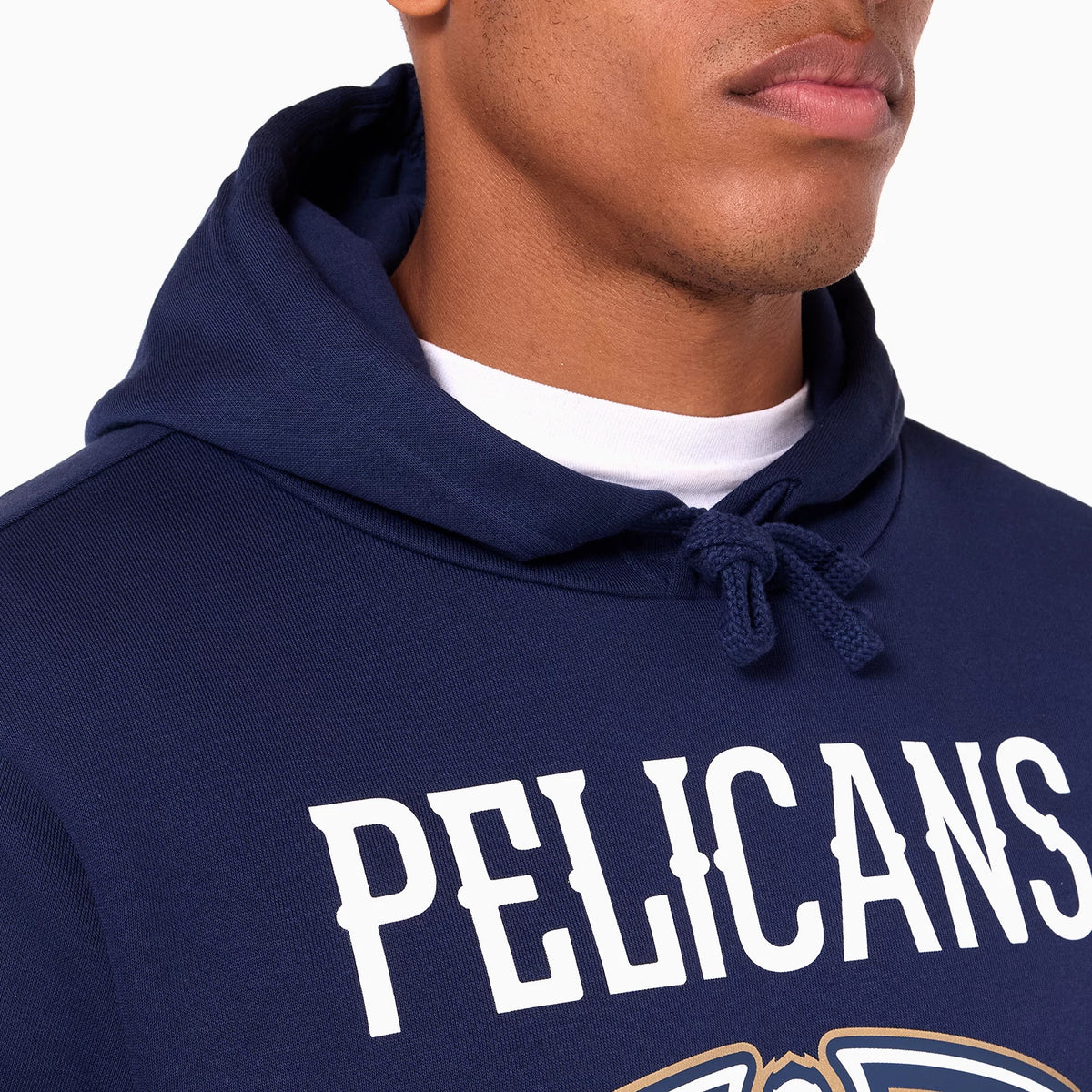 New Era New Orleans Pelicans NBA Navy Pullover Hoodie, front view showing the navy hood with drawstrings, white and gold New Orleans Pelicans logo below the large white PELICANS text across the chest.