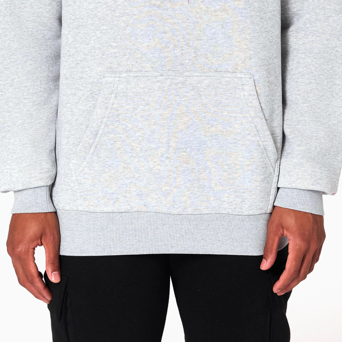New Era Houston Rockets NBA Grey Pullover Hoodie, front view showing the grey fabric with a large pocket at the centre, ribbed cuffs and hem, worn by a model with hands resting at the sides.