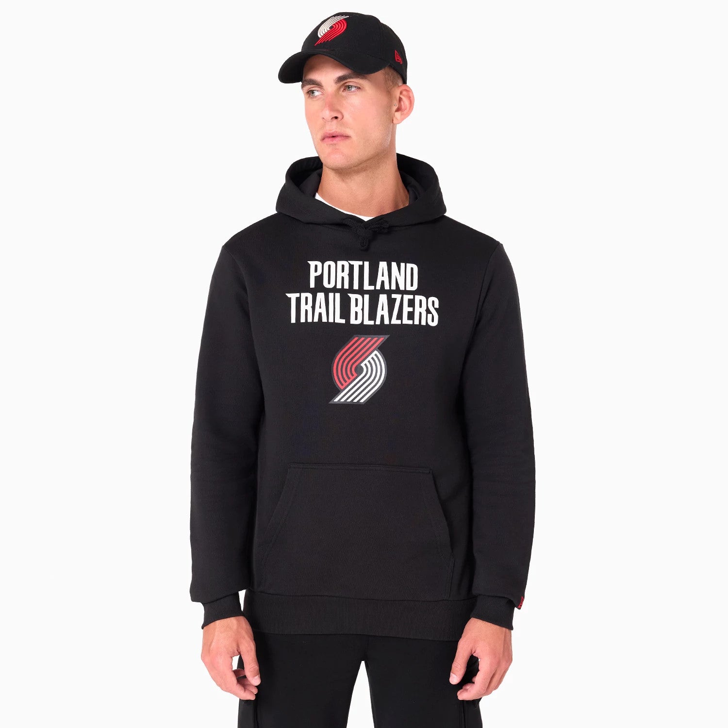 New Era Portland Trail Blazers NBA Black Pullover Hoodie, on-model view showing the black hoodie with 'PORTLAND TRAIL BLAZERS' text and the team's logo on the chest, featuring a kangaroo pocket and ribbed cuffs.