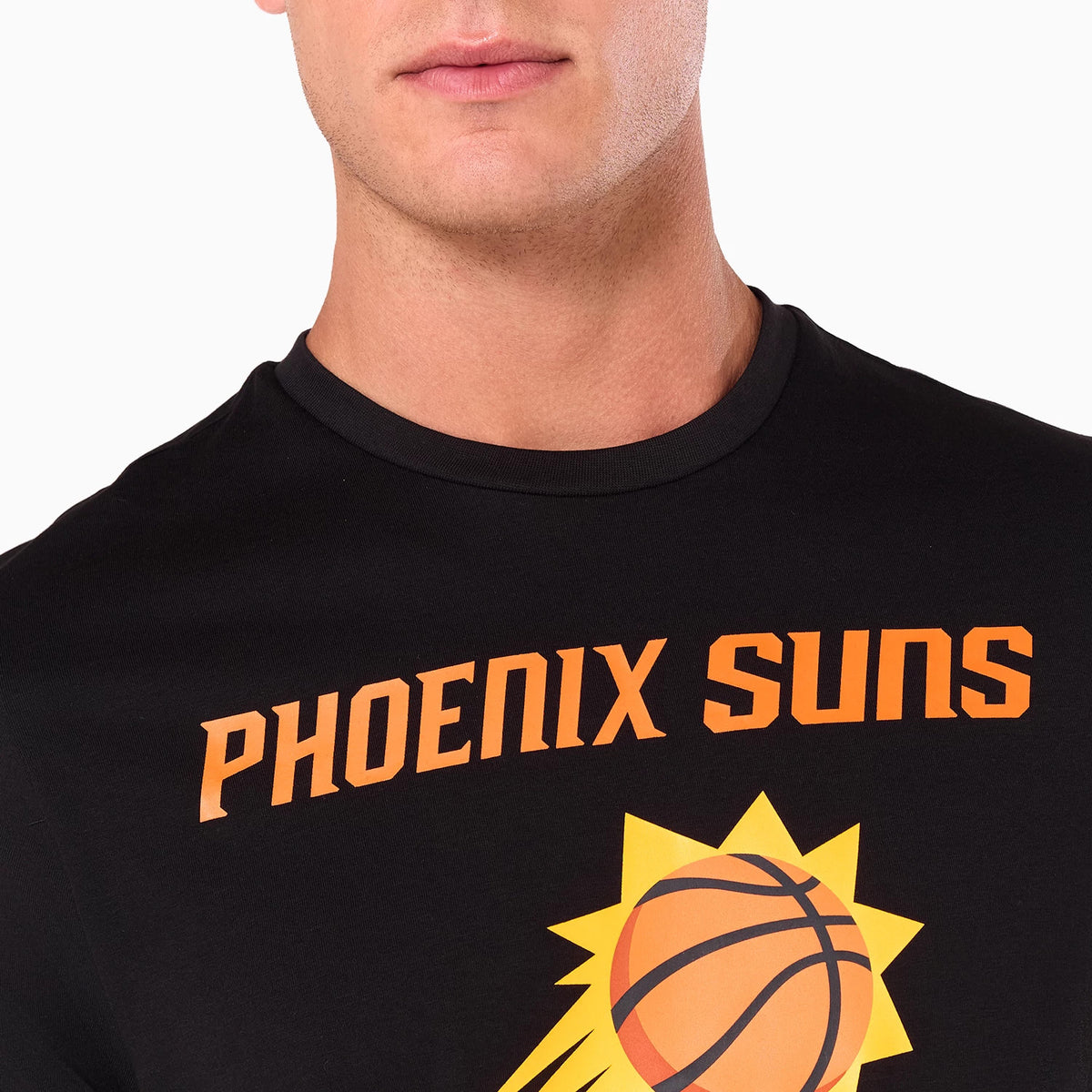 New Era Phoenix Suns NBA Black T-Shirt, front view showing the bold orange PHOENIX SUNS text arching over a stylised sun basketball logo printed on a black background against the fabric.
