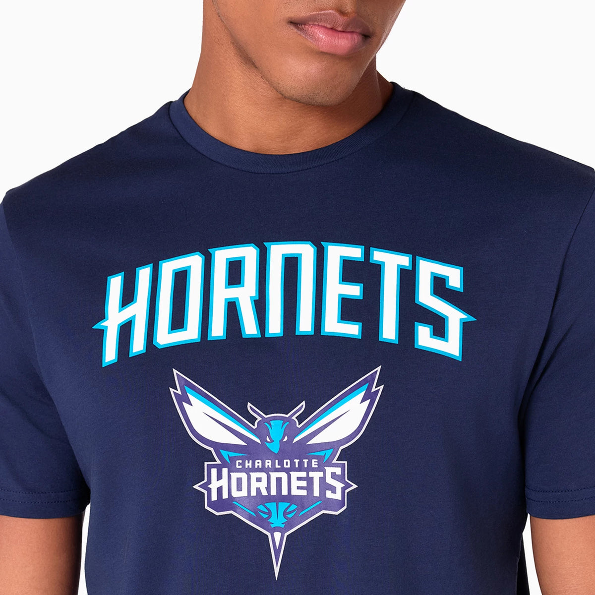 New Era Charlotte Hornets NBA Navy T-Shirt, front view showing the large Hornets text in white and teal across the chest, with the team's logo below featuring a stylized hornet, detailed in white, teal, and purple.