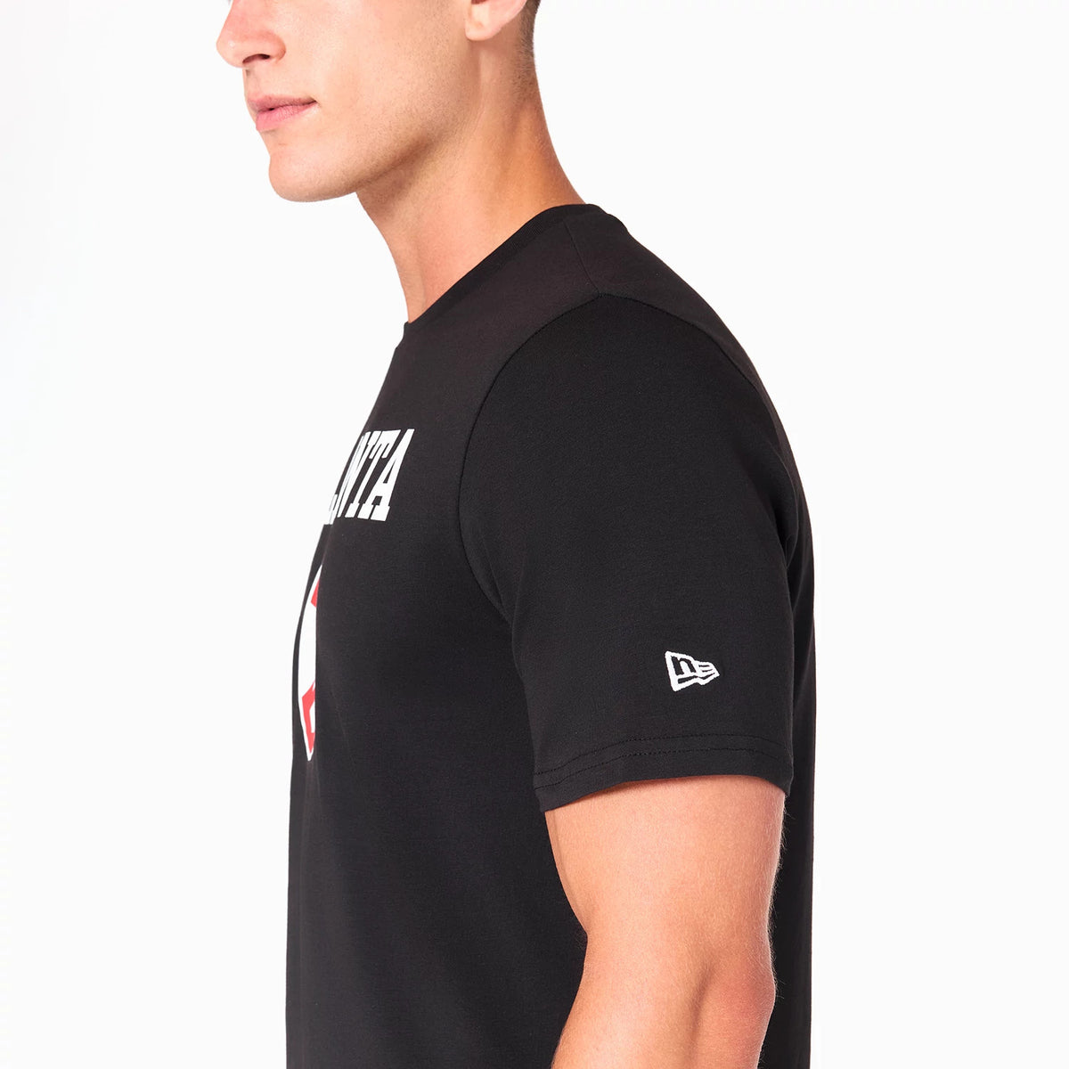New Era Atlanta Hawks NBA Black T-Shirt, side view showing the white debossed New Era logo on the sleeve and the partial ATLANTA text across the chest in white on a plain black background.