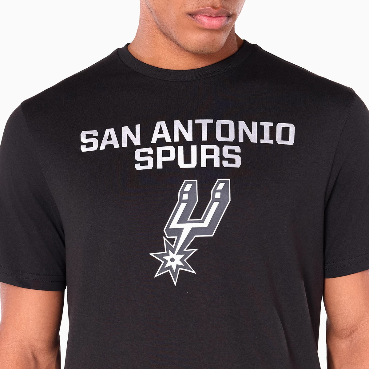 New Era San Antonio Spurs NBA Black T-Shirt, front view showing the large white printed text SAN ANTONIO SPURS across the chest and the team's logo printed prominently in white below on a plain black fabric.