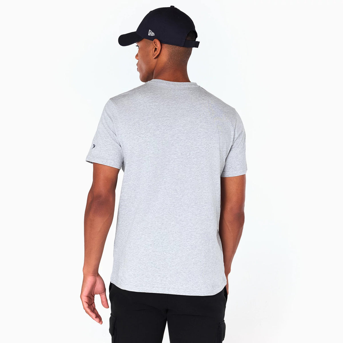 New Era Denver Nuggets NBA Grey T-Shirt, on-model view from the back showing the light grey short-sleeved shirt with a small embroidered logo on the left sleeve and a black cap featuring a raised logo on the side.