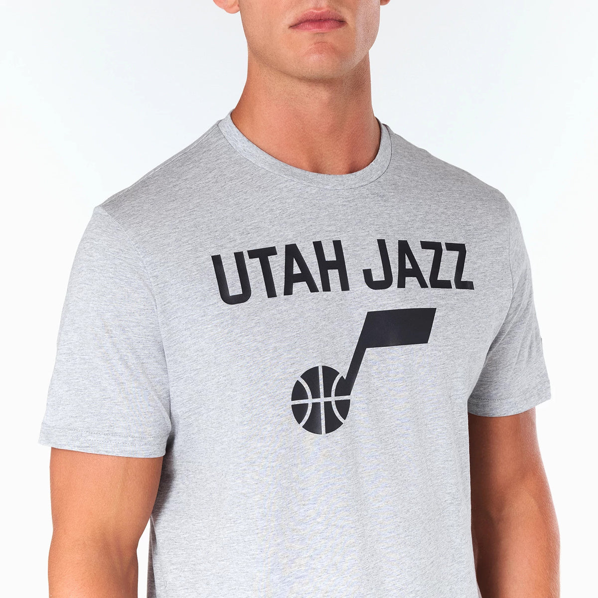 New Era Utah Jazz NBA Grey T-Shirt, front view showing the grey fabric with a bold black Utah Jazz logo printed prominently on the chest.