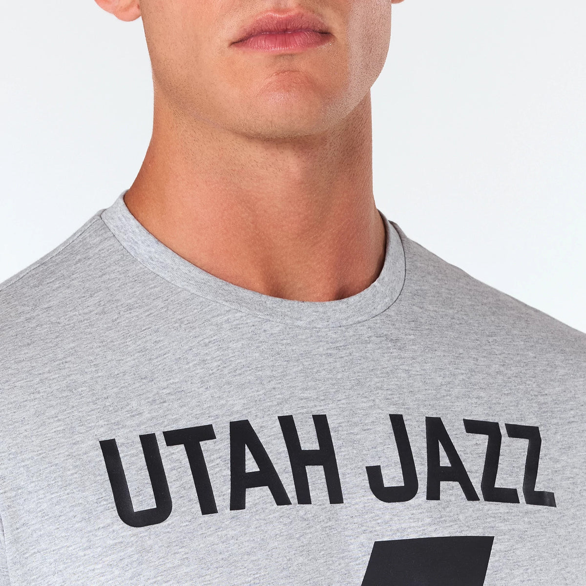 New Era Utah Jazz NBA Grey T-Shirt, front view showing the grey fabric with bold black UTAH JAZZ text across the chest.