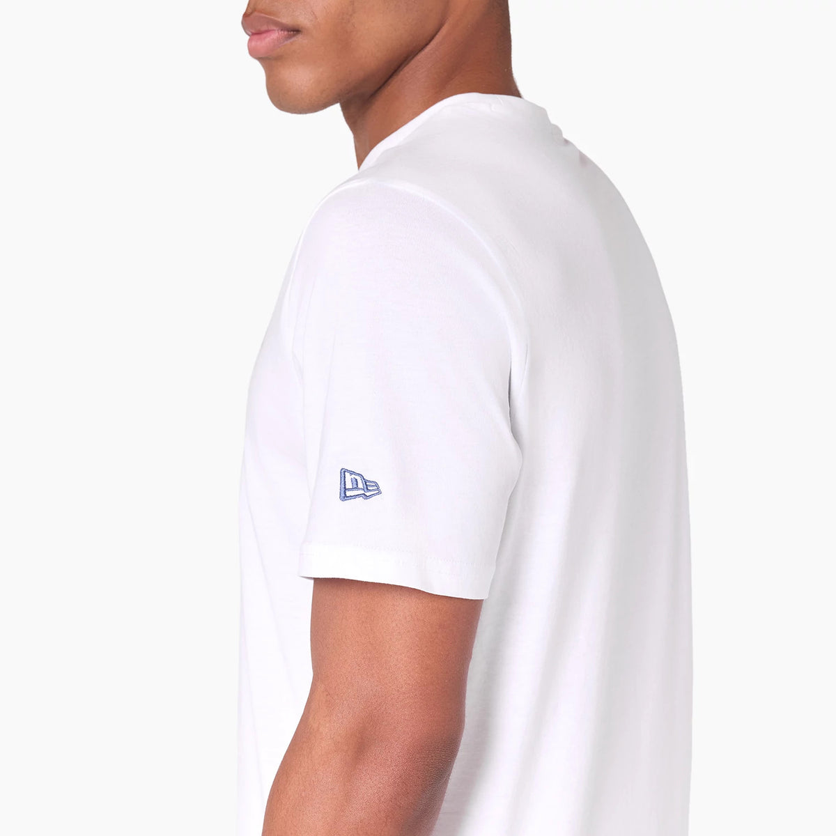New Era Minnesota Timberwolves NBA White T-Shirt, side view showing the short sleeve with a raised blue and white New Era logo embroidered near the hem, part of the plain white shirt visible from shoulder to hem.
