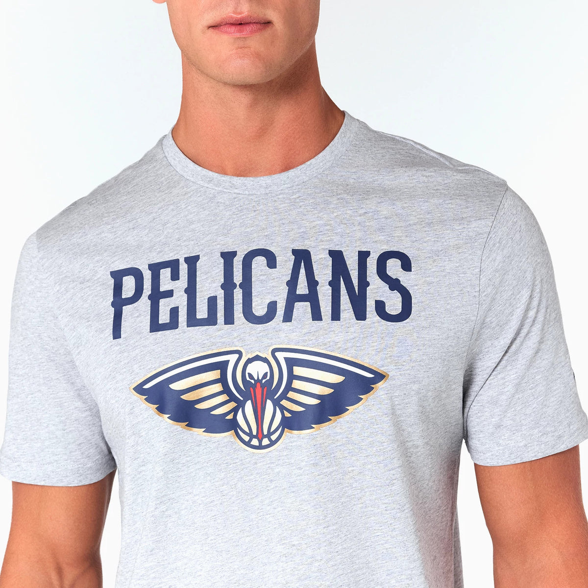 New Era New Orleans Pelicans NBA Grey T-Shirt, front view showing a large printed team logo with stylized wings beneath the word PELICANS in bold navy text on a light grey background.