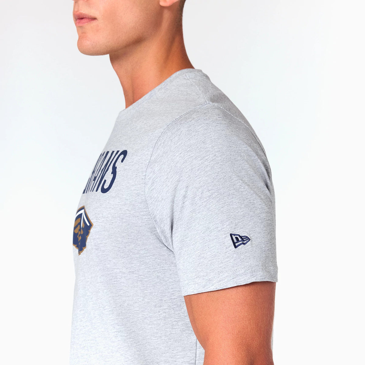 New Era New Orleans Pelicans NBA Grey T-Shirt, side view showing the light grey fabric with the New Era logo embroidered on the sleeve and the team name printed in navy blue across the chest above the team emblem.