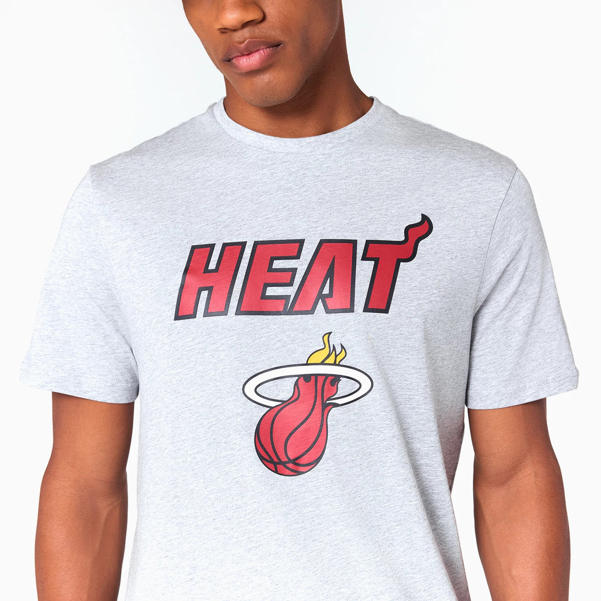 New Era Miami Heat NBA Grey T-Shirt, front view showing the red and black HEAT text with a flaming basketball logo beneath, both centrally printed on the chest of the light grey fabric.