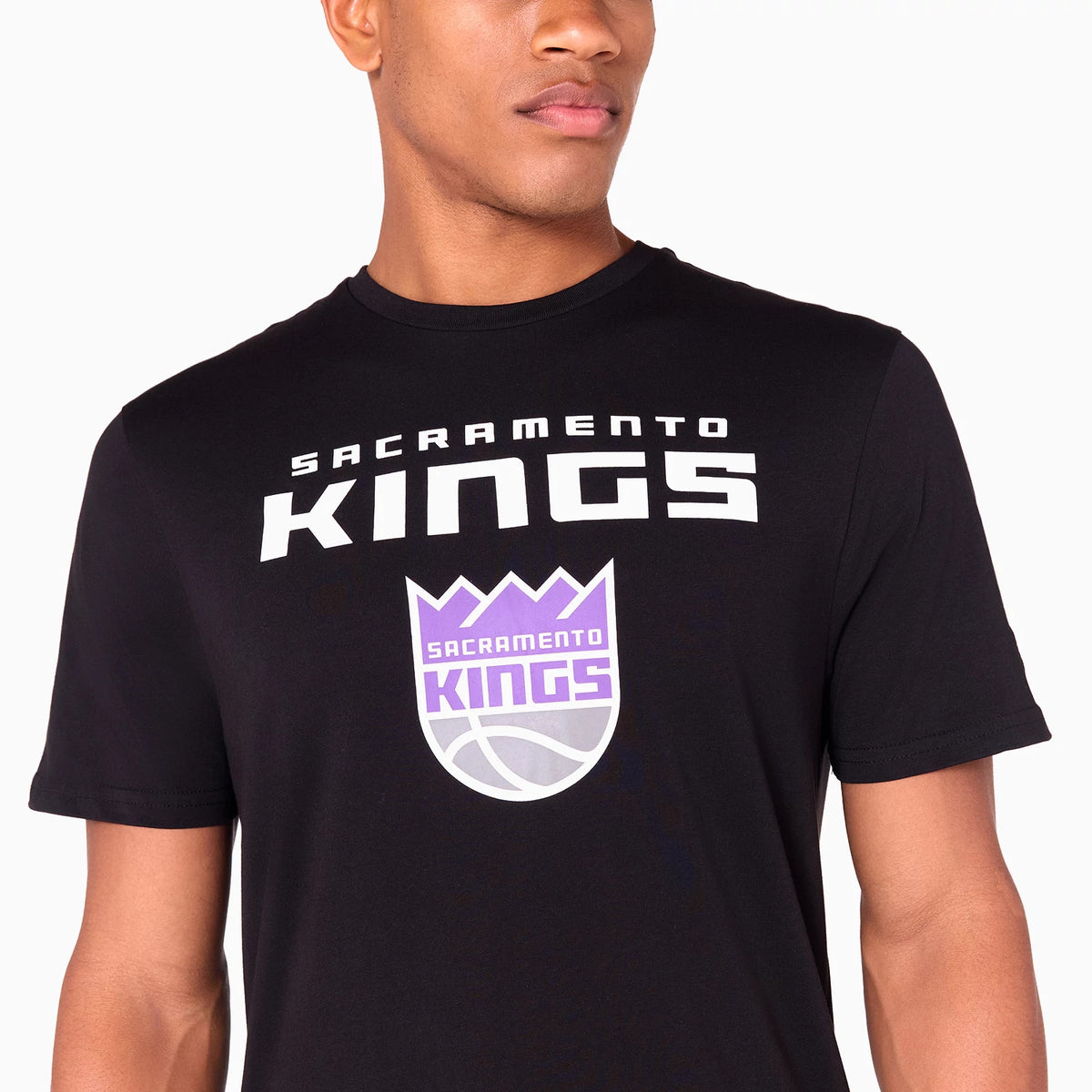 New Era Sacramento Kings NBA Black T-Shirt, on-model view showing a white KINGS print across the chest above a large purple Sacramento Kings logo, short sleeves, and a round neckline.