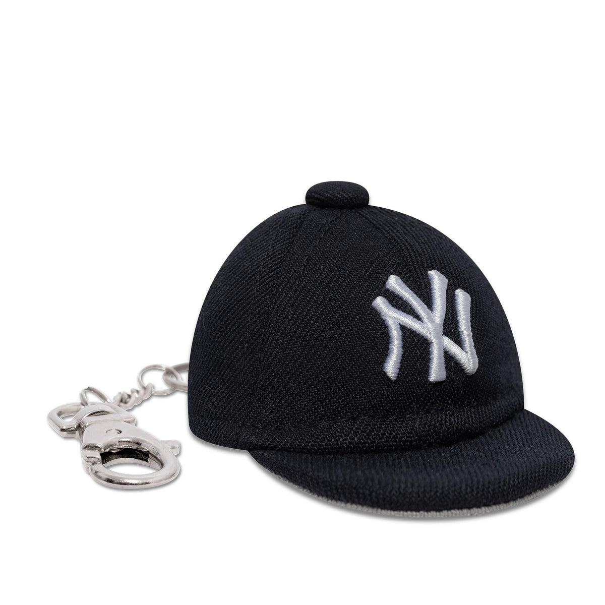New Era New York Yankees MLB Mini Cap Navy Key Chain, three-quarter view showing the white NY logo embroidered on the front panel of the navy mini cap, accompanied by a silver key chain attachment at the back.