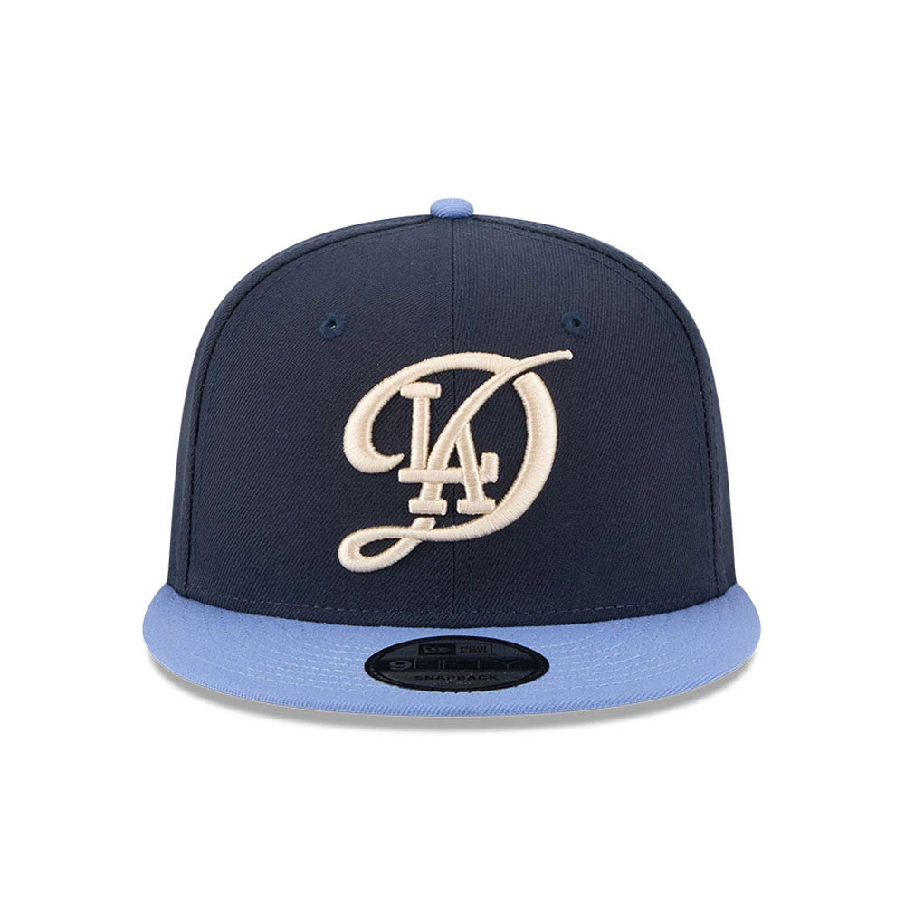 LA Dodgers MLB Evergreen Dark Blue New Era 9FIFTY Snapback Adjustable Cap, front view showing a raised white LA logo embroidered on the dark blue crown with a light blue visor and a 9FIFTY size sticker.