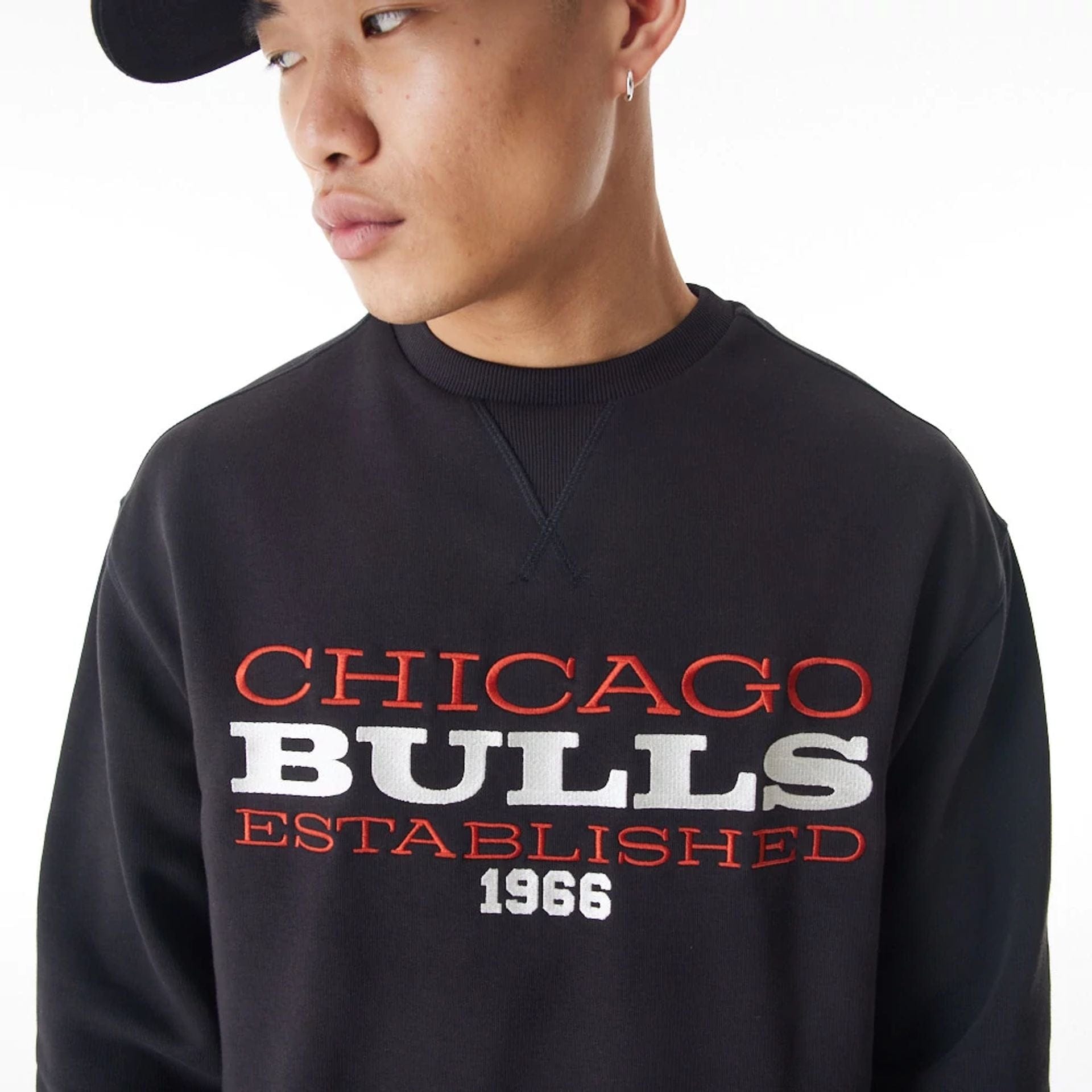 The Male model is wearing Chicago Bulls NBA Lifestyle Black Oversized Crew Neck Sweater 1