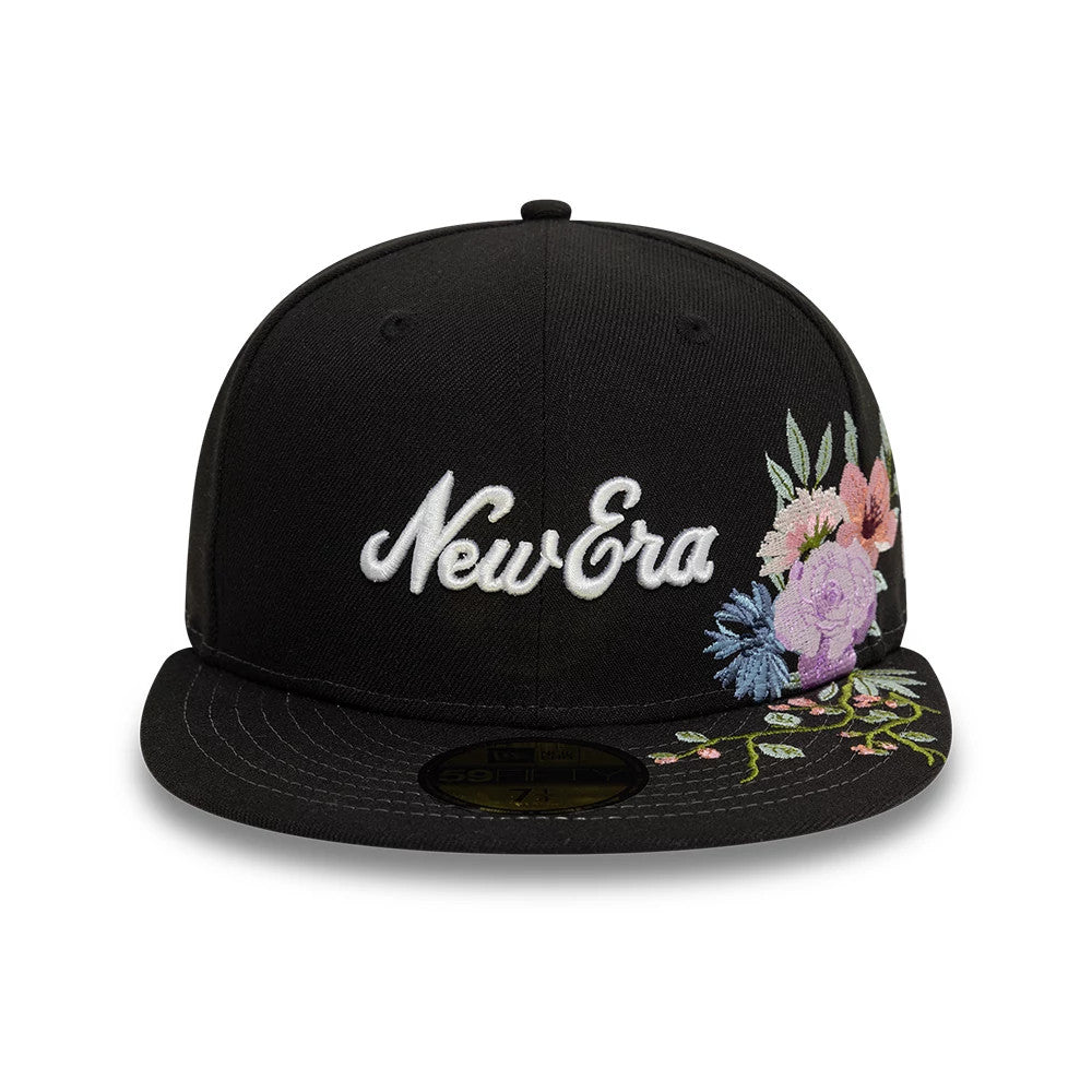 New Era Floral Emblem Black New Era 59FIFTY Fitted Cap, front view showing white script logo embroidery with multicoloured floral design on the right side and visor, featuring a gold 59FIFTY size sticker on the black visor.