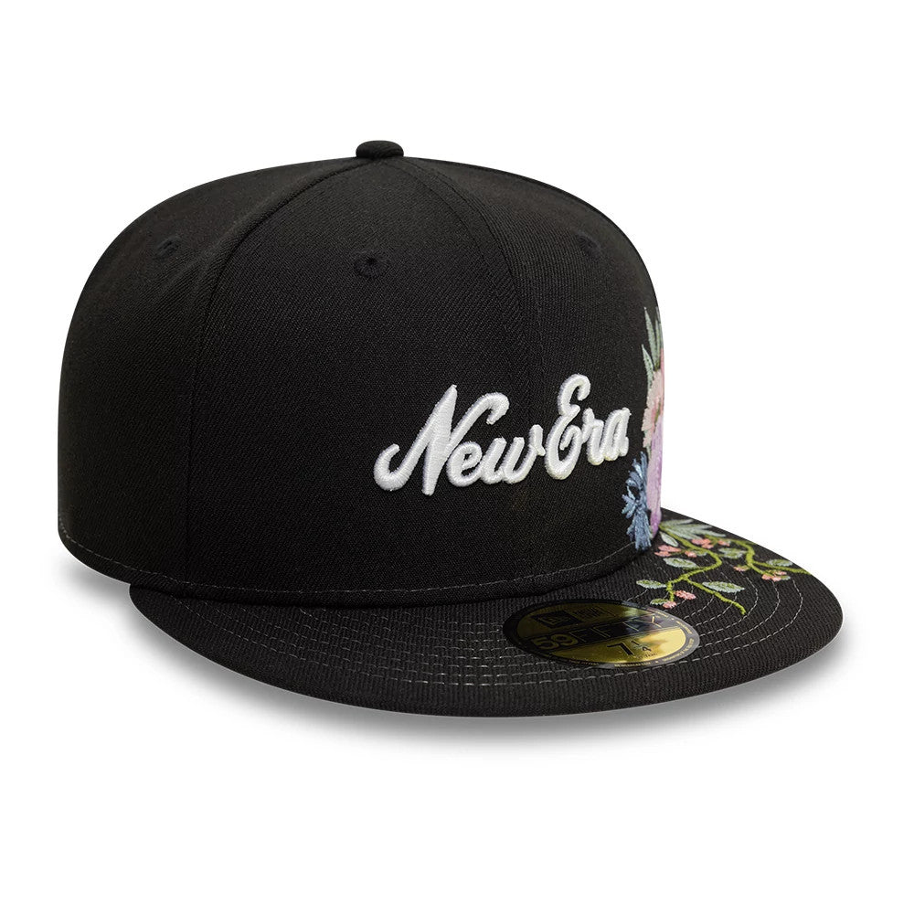 New Era Floral Emblem Black New Era 59FIFTY Fitted Cap, three-quarter view showing white script logo embroidered on the front panel, colourful floral embroidery on the visor and side, and gold 59FIFTY size sticker on the visor.