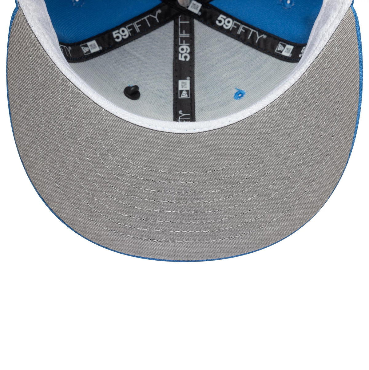 New Era Oversized Script Blue New Era 59FIFTY Fitted Cap, inside view showing the grey undervisor with blue edging and 59FIFTY labelled black taping above a white sweatband lining the blue interior crown.