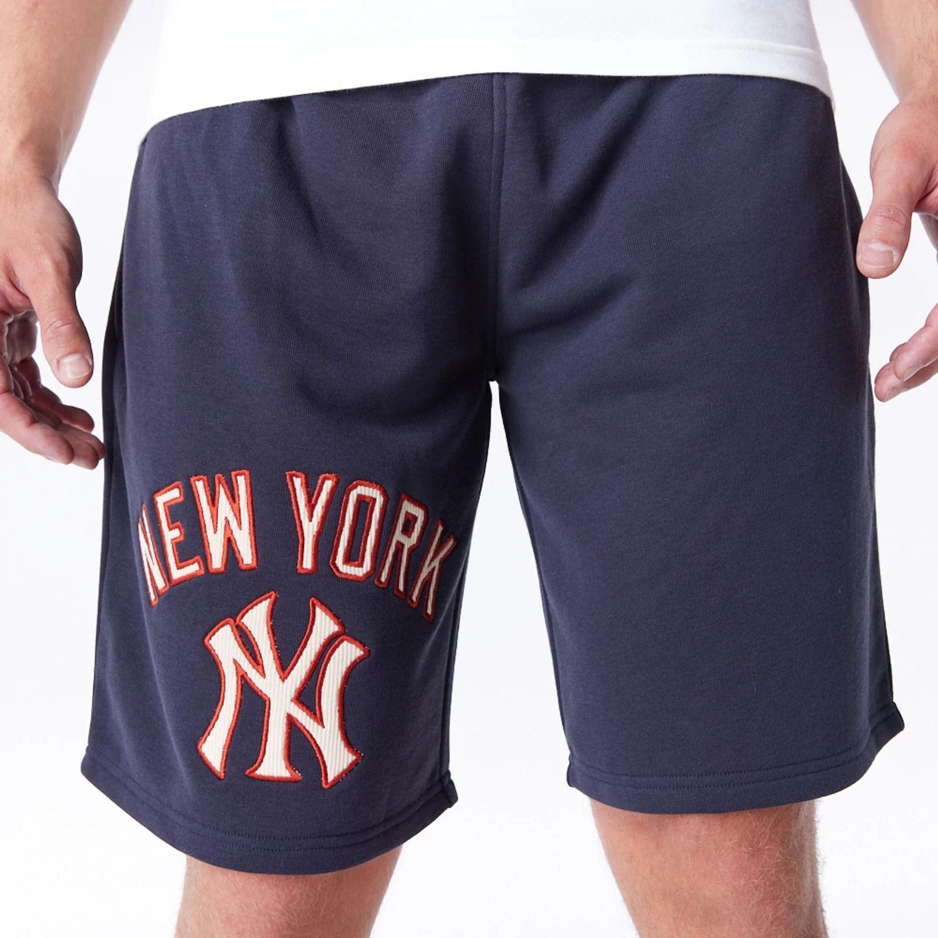 The Male model is wearing New York Yankees MLB Lifestyle Navy Shorts 1