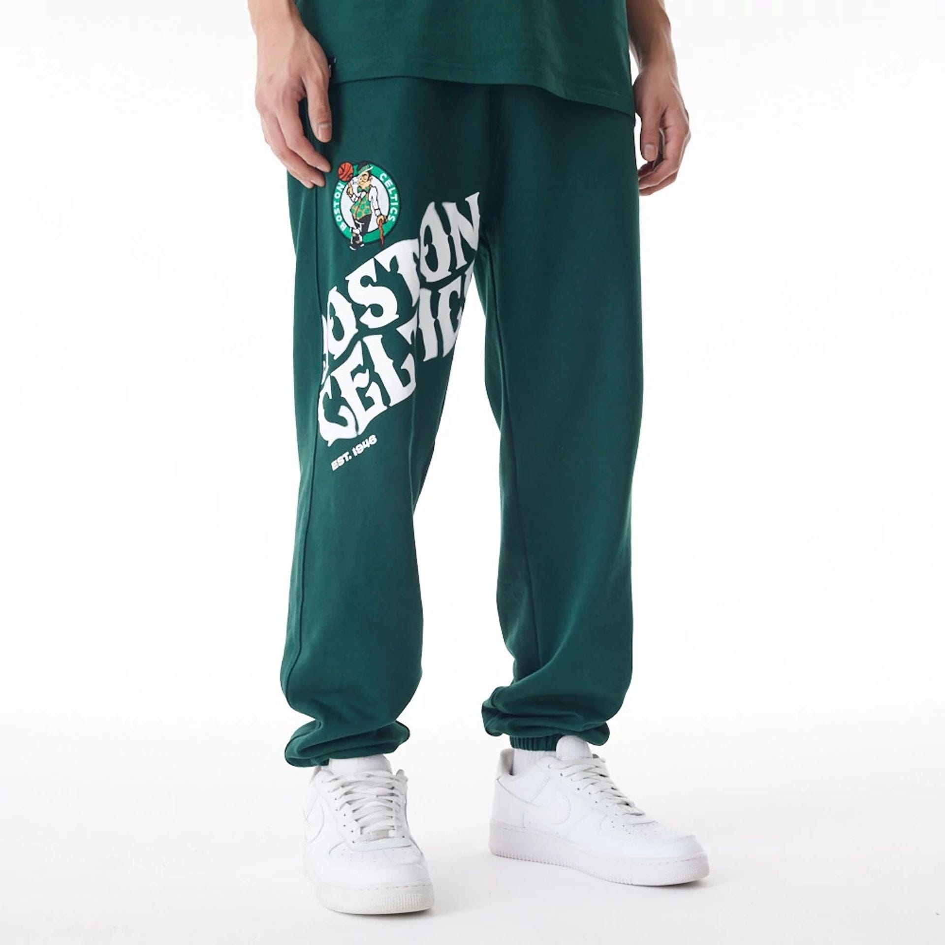 The Male model is wearing Boston Celtics NBA Graphic Dark Green Joggers 1
