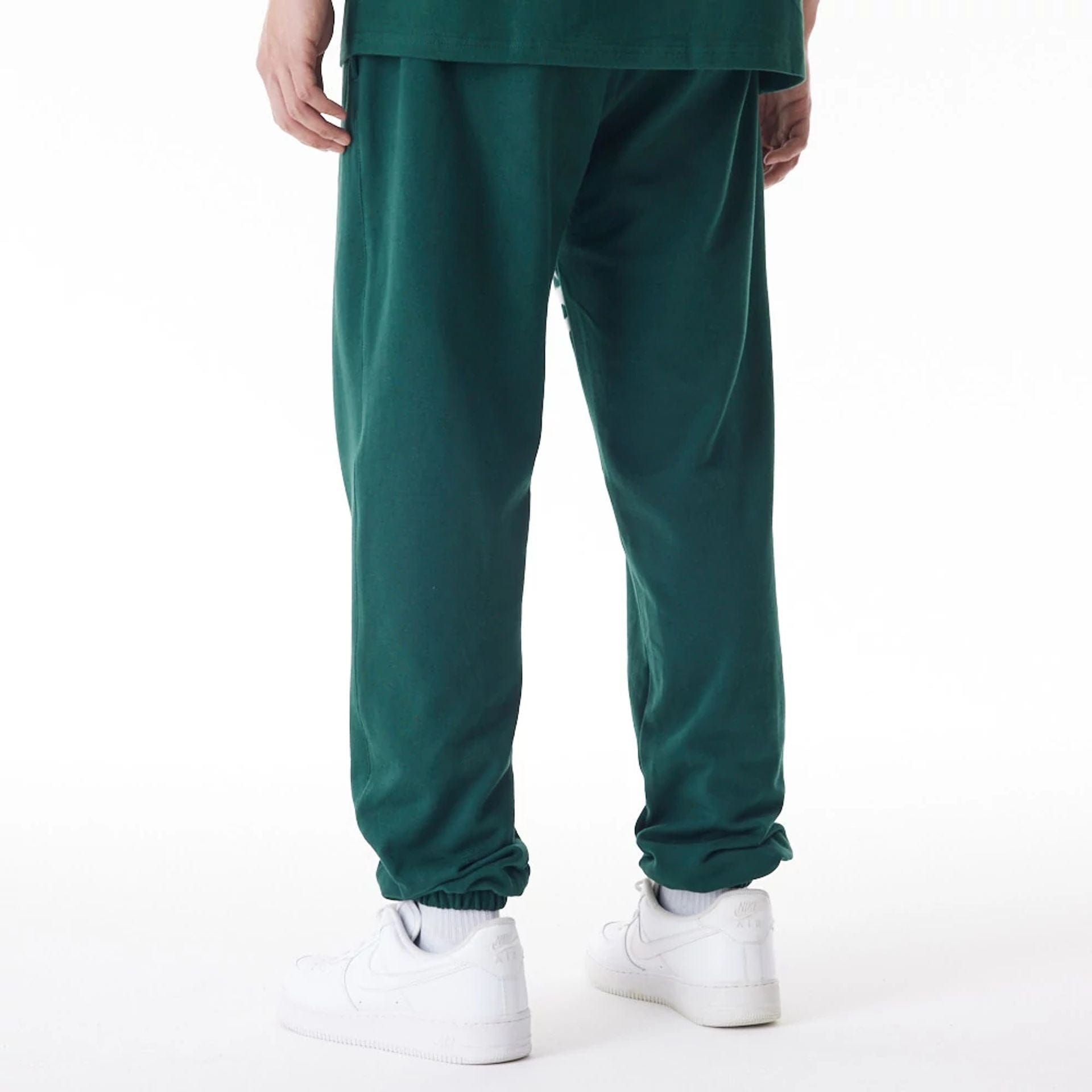 The Male model is wearing Boston Celtics NBA Graphic Dark Green Joggers 2