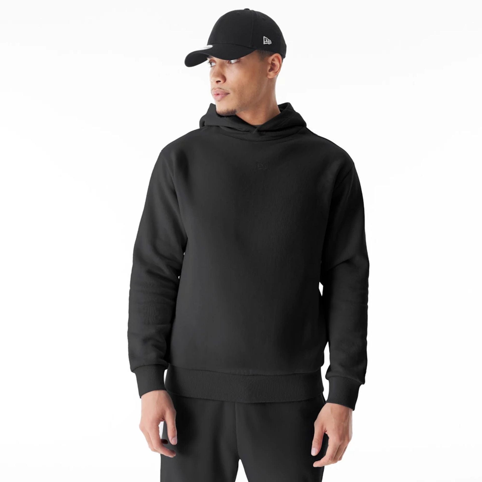 The Male model is wearing New Era Flag Black Oversized Pullover Hoodie 1