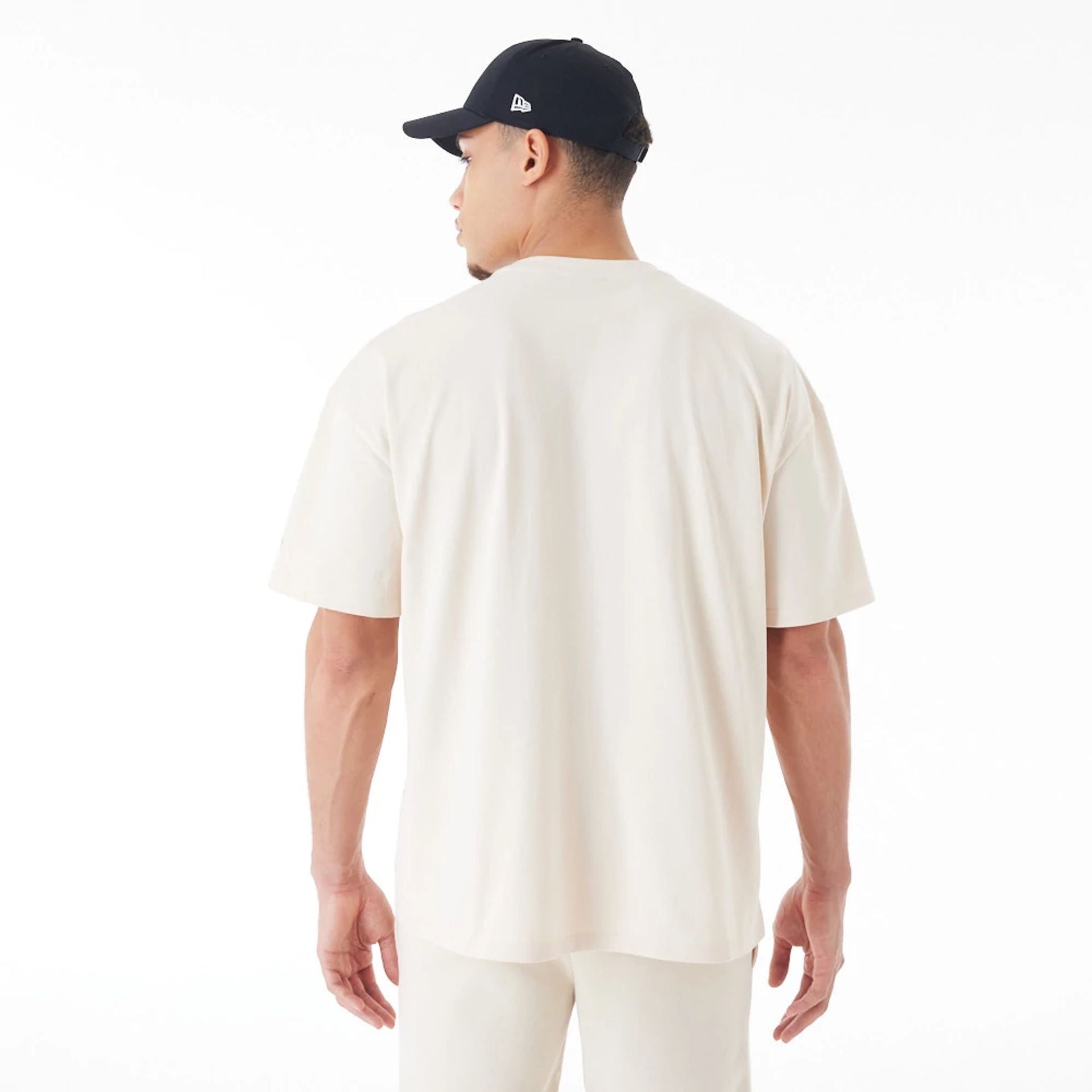 The Male model is wearing New Era Flag Cream Oversized T-Shirt 2