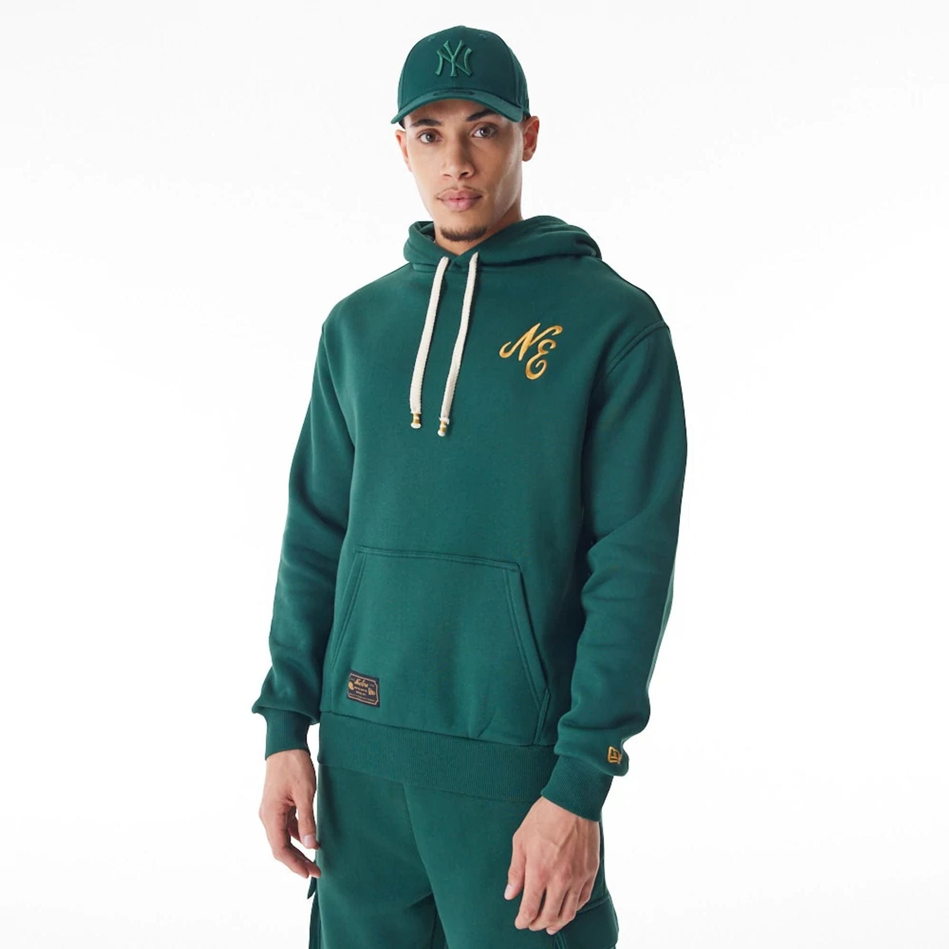 The Male model is wearing New Era Script Logo Dark Green Oversized Pullover Hoodie 2