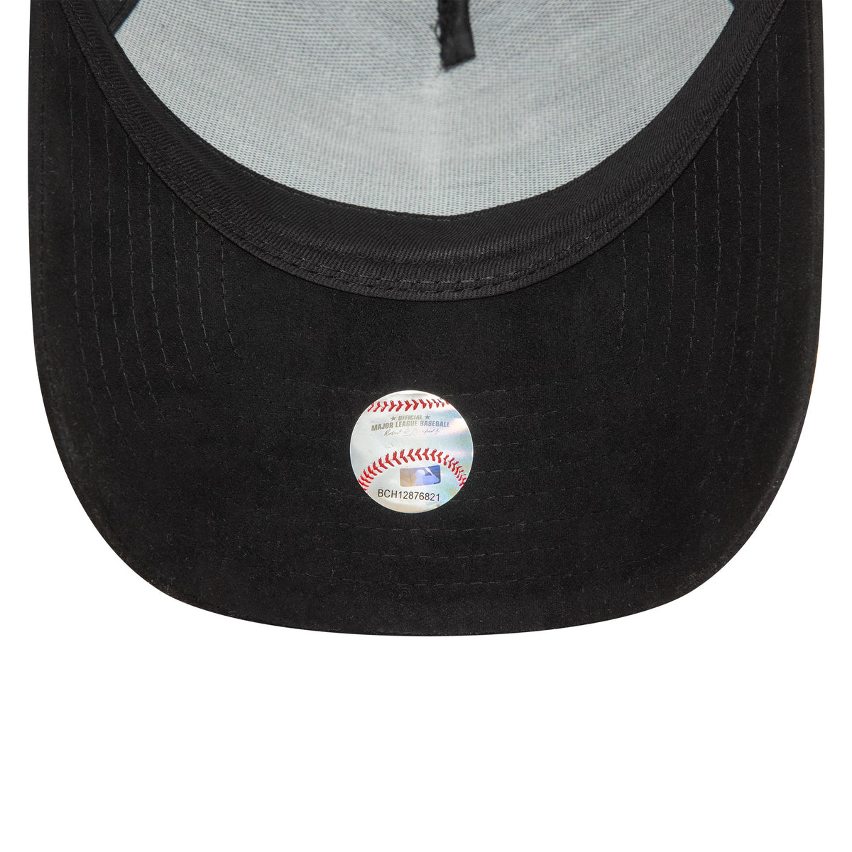 New York Yankees Faux Suede Black New Era 9FORTY E-Frame Cap, inside view showing the black sweatband and light grey taping, with a small baseball-shaped sticker on the black undervisor.